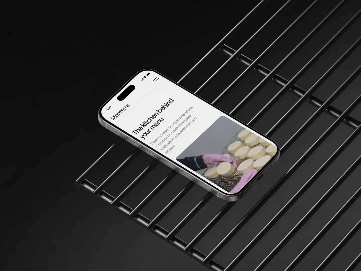 Monterra Foods website shown on a phone in a commercial kitchen setting.